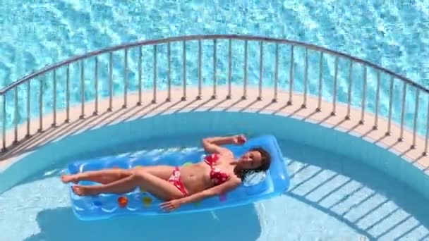 Pretty woman in swimsuit on air mattress — Stock Video