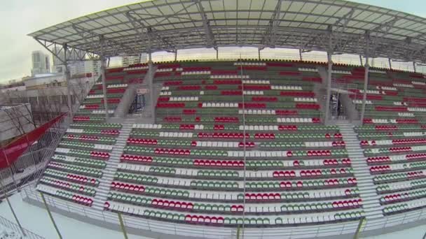 Empty tribunes of football stadium in winter — Stock Video