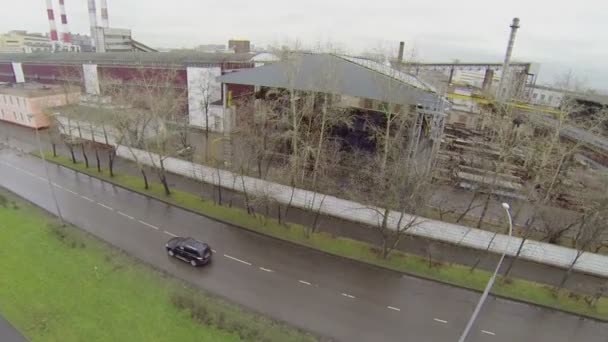 Cars ride near reinforced concrete plant — Stock Video