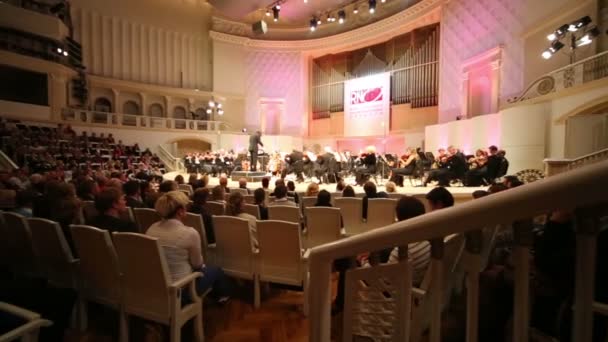 Spectators look at musicians in Concert Hall.