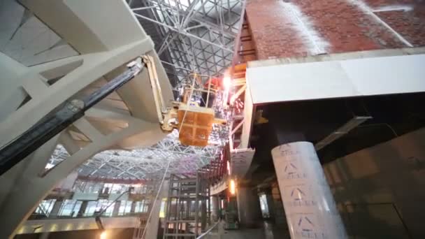 Welder working in platform on construction of terminal — Stock Video