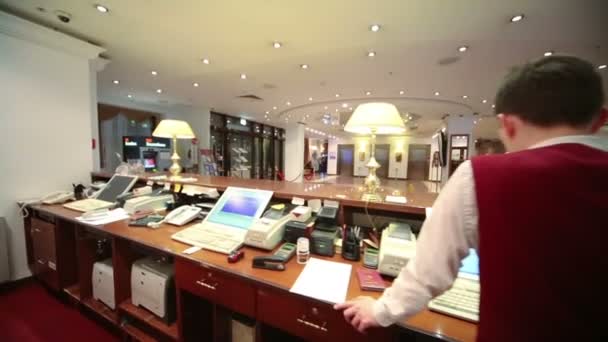 Receptionist dietro la reception dell'hotel — Video Stock