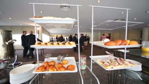 Trays of pastries, sandwiches, buns and people — Stock Video