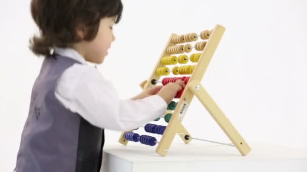 Little happy boy with colorful abacus — Stock Video