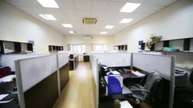Workplaces with computers and separated by partitions