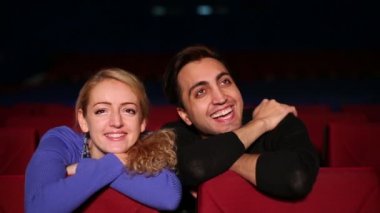 young man and woman watch movie