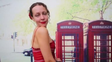 Woman in red dress poses with bike