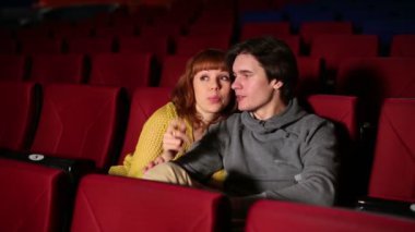 Young man with woman watch movie