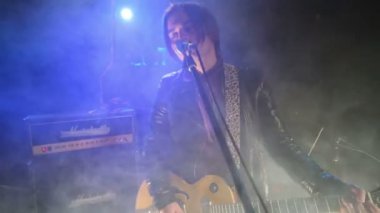 Young man with guitar sings