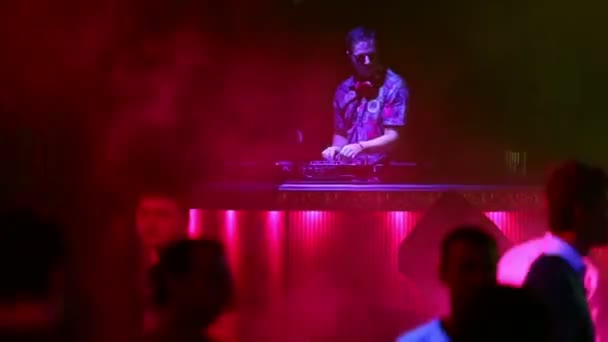 DJ mixes records and people dancing — Stock Video