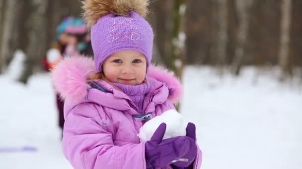 Happy little girl throwing up snowball — Stock Video