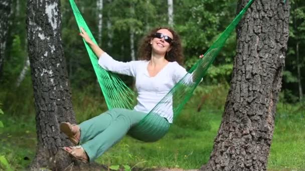 Young smiling woman in hammock — Stock Video