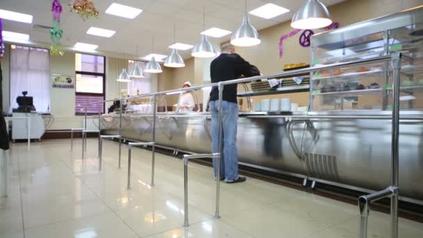 Man buys food in dining room — Stock Video