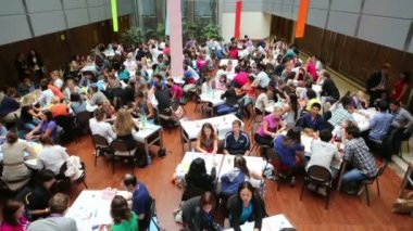Young people discussing at tables