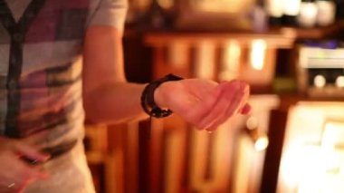 young bartender ignites mixture on palm