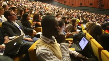 Audience listens to report at Global Youth