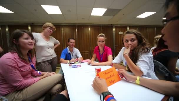 Young people sitting at table — Stock Video