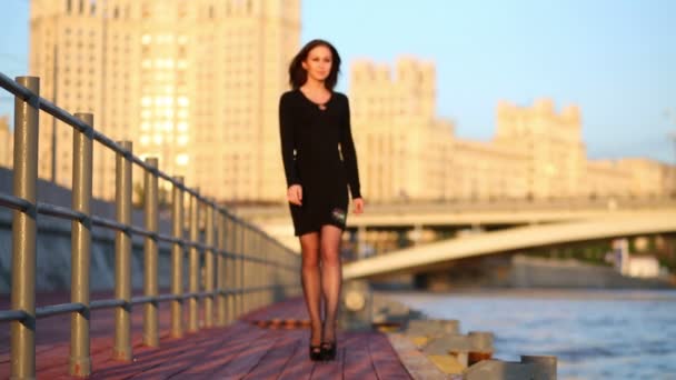 Young woman walking at waterfront — Stock Video