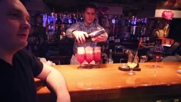 Young handsome bartender makes cocktails — Stock Video