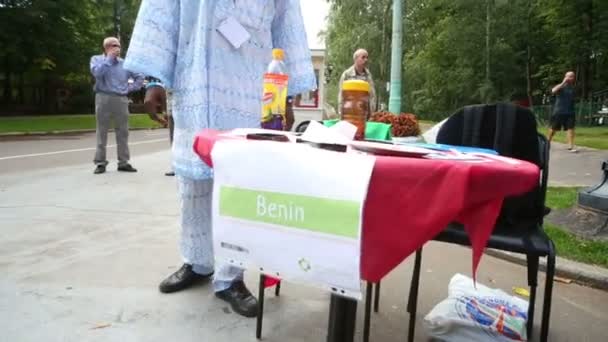 Homme montrant le drapeau du Bénin à l'exposition — Video