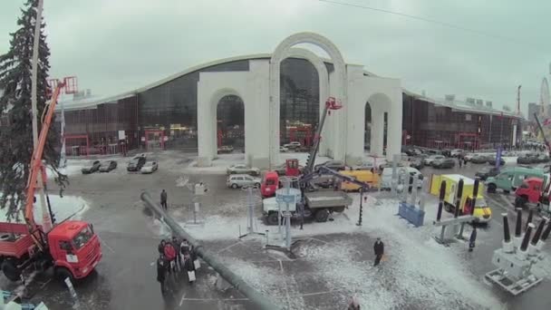 People walk among equipment near Mosexpo — Stock Video