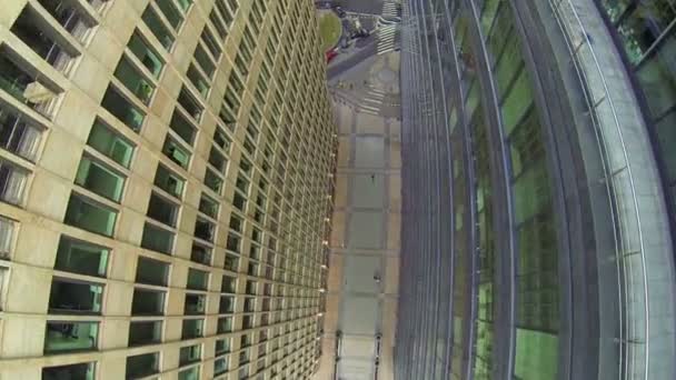 Människor går med gångstig mellan byggnaderna — Stockvideo