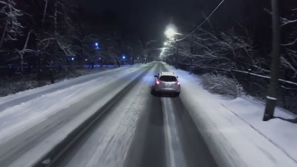 Car drives by snow-covered road — Wideo stockowe