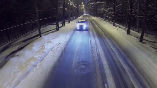 Car rides by snowbound road — Stock Video