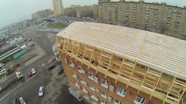 Wooden frame of roof on brick building — Stockvideo