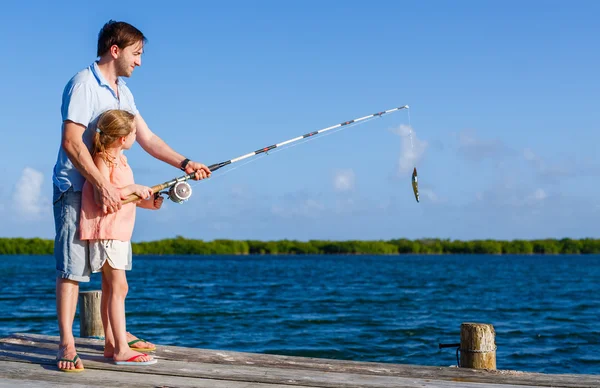 Family fishing from wooden jetty — Stock Photo, Image