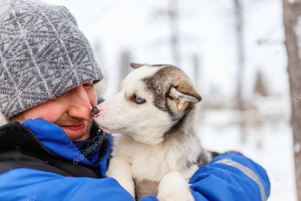 Man with husky puppy