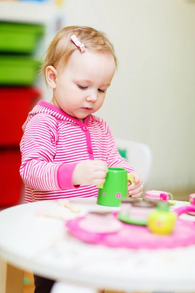Маленькая девочка, играющая с игрушками — стоковое фото