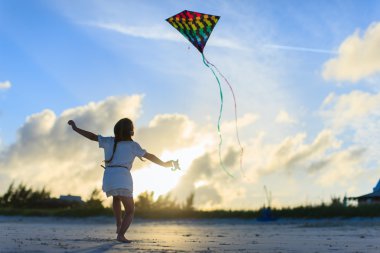 Little girl flying a kite clipart