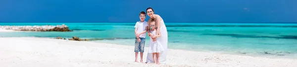 Mother and kids on a tropical beach — Stock Photo, Image