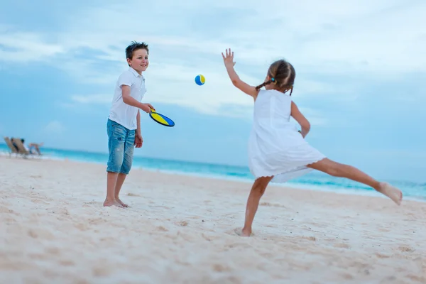 Дети играют в пляжный теннис — стоковое фото