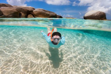 Woman snorkeling in tropical water clipart