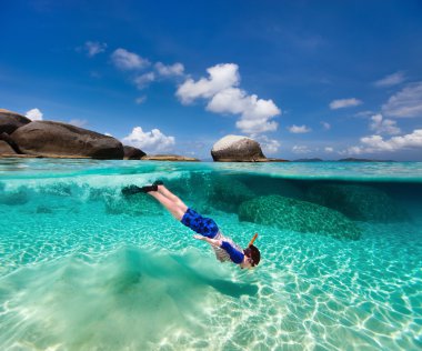 Little boy snorkeling in tropical water clipart