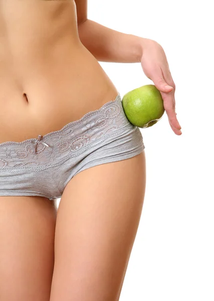 Женщина в нижнем белье держит яблоко — стоковое фото