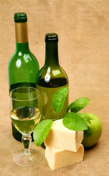 Wine bottles and cheese — Stock Photo, Image