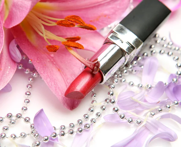 Lipstick and pink flower — Stock Photo, Image