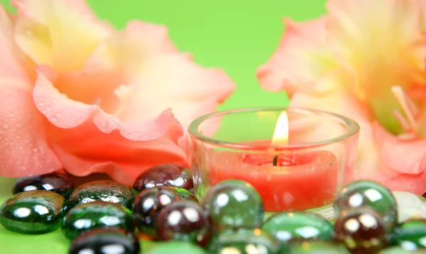 Flores de lírio, velas e pedras decorativas — Fotografia de Stock