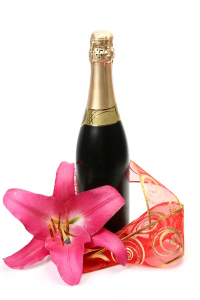 Champagne and lily with red ribbon — Stock Photo, Image