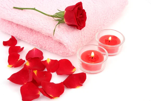 Towel , rose and  burning candles Royalty Free Stock Images