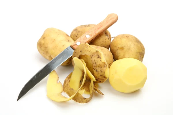 Raw potatoes and knife Stock Picture