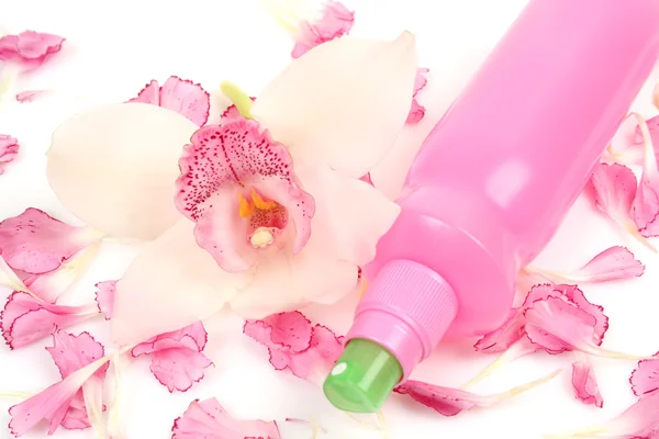 Garrafa cosmética com orquídea e pétalas — Fotografia de Stock
