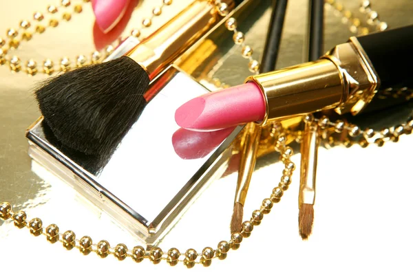 Pink lipstick with makeup brush — Stock Photo, Image