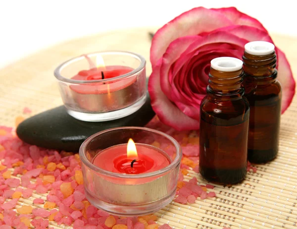 Aromatic oil and rose and candles — Stock Photo, Image