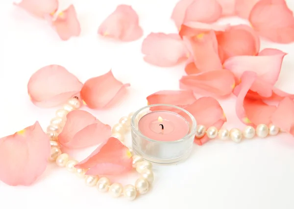 Petals, pearls and candle — Stock Photo, Image