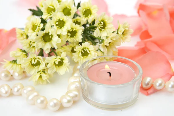 Yellow flowers and candles — Stock Photo, Image