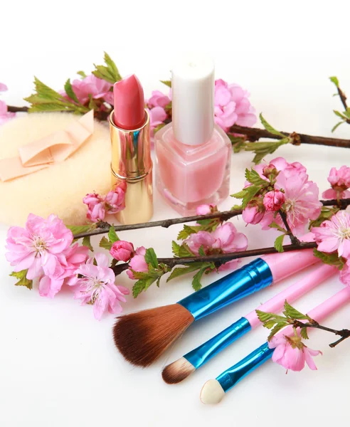 Decorative cosmetics and flowering branches — Stock Photo, Image